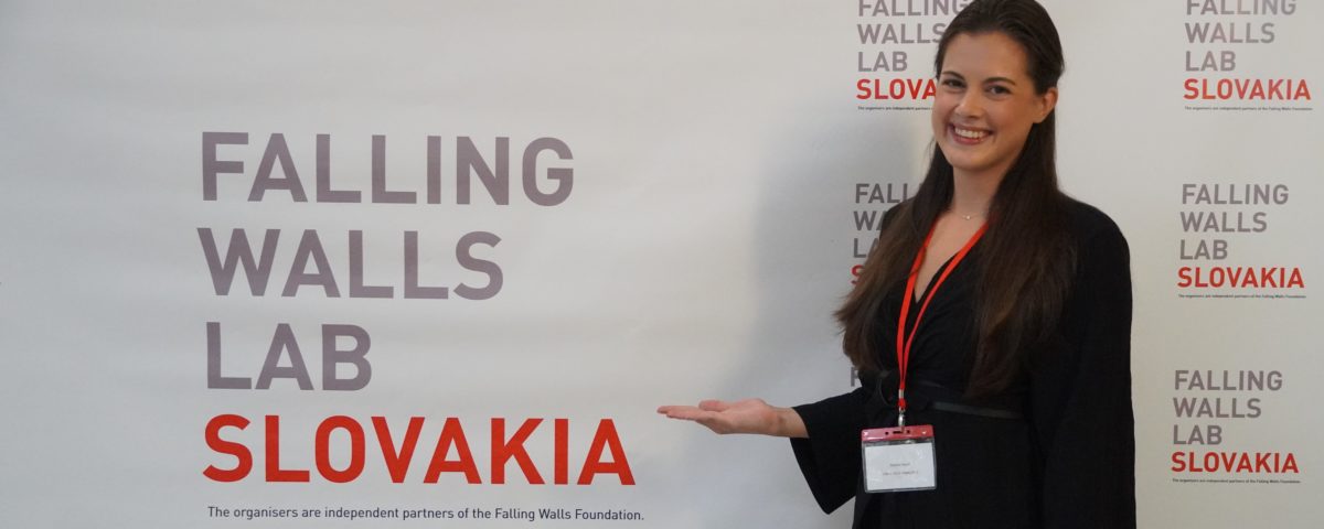 Dr. Danica Ivovič in front of the competition photo wall.